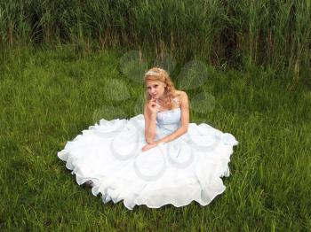 Royalty Free Photo of a Bride Sitting in a Field