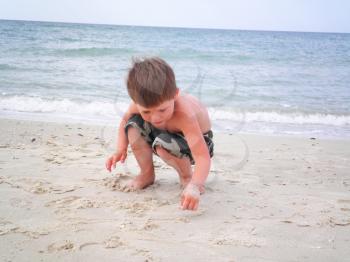 Royalty Free Photo of a Boy Playing at the Beach