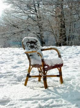 Wicker chair on a snowy meadow. Netherlands