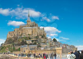 Tourists on the way to the abbey of Mont Saint Michel. Normandy, France