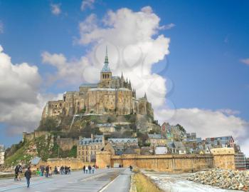 Tourists on the way to the abbey of Mont Saint Michel. Normandy, France