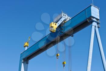 Gantry crane at shipyard on the background of blue sky