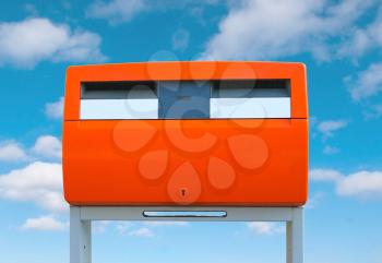 Dutch public mailbox orange on sky background Netherlands
