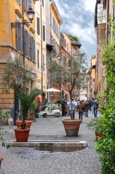 ROME, ITALY - MAY 03, 2014: People on the narrow picturesque street in Rome, Italy 