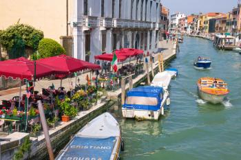 VENICE, ITALY - MAY 06, 2014:  Outdoor cafes on the canal in  Venice, Italy