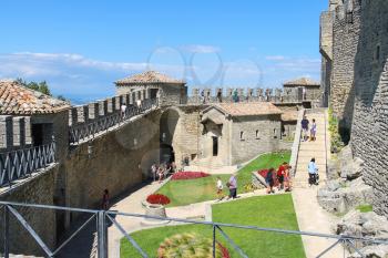 SAN MARINO. SAN MARINO REPUBLIC - AUGUST 08, 2014: Tourists see the sights in courtyard of fortresses Guaita on Mount Titan. The Republic of San Marino