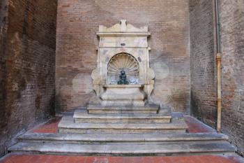 Old fountain with small boy on a dolphin on Cavour square in Rimini, Italy