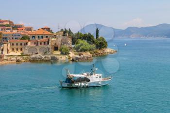 Small boat in the waters of the Tyrrhenian Sea. Portoferraio from the sea, Elba island, Tuscany, Italy