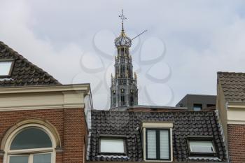 The bell tower of the Grote Kerk (Sint-Bavokerk) over the roofs in the  historic center of Haarlem, the Netherlands