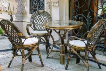Outdoor street cafe with wooden furniture in touristic city centre
