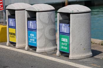 Piombino, Italy - June 30, 2015: Bins for different types of garbage on the pier