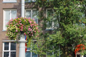 Decorative flowers on a pole near the building in Amsterdam, the Netherlands
