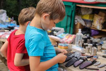 Two boys looking at souvenirs in the market of Schodnica, Ukraine