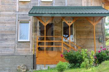Wooden porch and veranda of modern cottage. Carpathians, Ukraine