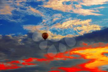 Bright balloon in sunset colorful sky