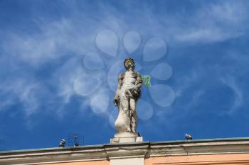 Antique statue on facade of Governor Palace in Piacenza, Italy