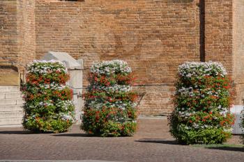 Decorative floral columns on ancient basilica background. Piacenza, Italy