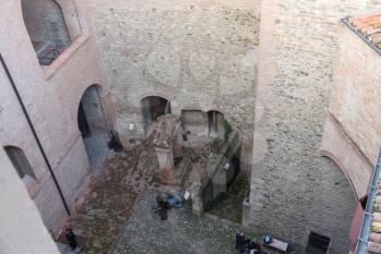 Vignola, Italy - October 30, 2016: Tourists near decorative sculptural installations in ancient fortress. Emilia-Romagna, Modena