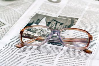 Royalty Free Photo of Reading Glasses on a Newspaper