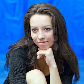 portrait of a young girl on  blue background