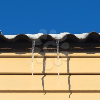 two icicles hanging from the roof