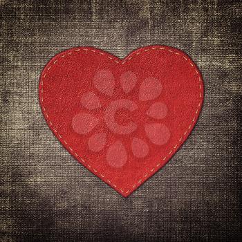 red leather heart on fabric in grunge style