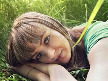 Young beautiful girl lying on the grass