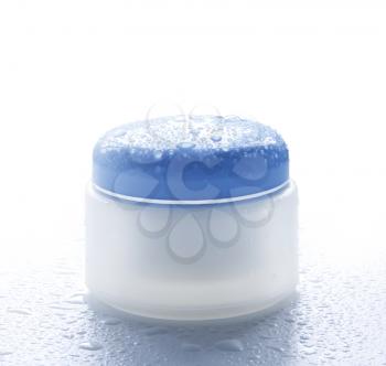 Cosmetic cream for skin care in the water droplets