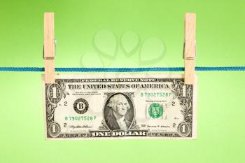 Royalty Free Photo of a Dollar Bill Hung on a Clotheline
