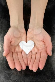 Royalty Free Photo of a Woman Holding a Paper Heart