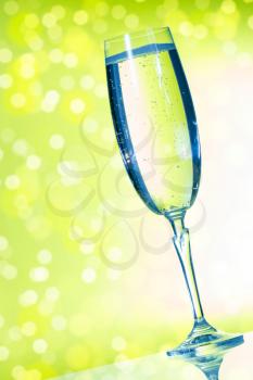 Elegant champagne glasses on the green background 