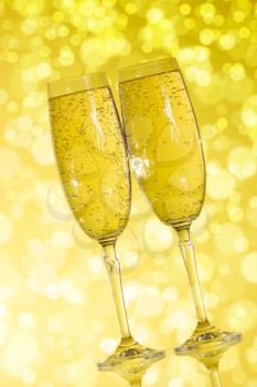 Elegant champagne glasses on the yellow background