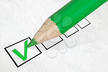 Green pencil marking check box. Concept for customer satisfaction survey or education research