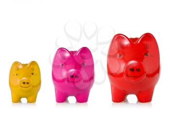 Growing investment concept.Three piggy banks of increasing size over a white background.