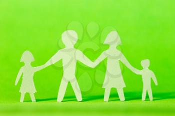 Family cutout shape isolated against a green background 