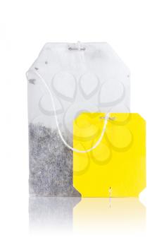 Teabag with yellow label. Isolated on white background 