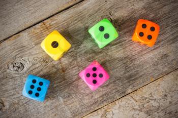Colorful dice on the old wooden floor