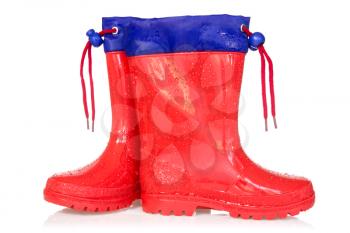 Red rain boots over a white background