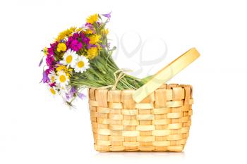 Wicker basket with a bouquet of wildflowers. Isolated on white background.
