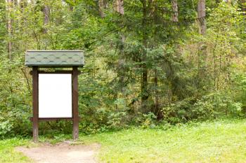 Blank wooden billboard  in  the green forest 