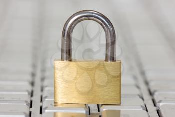 IT safety concept, golden lock on the keyboard