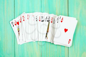Deck of playing cards on blue wooden background