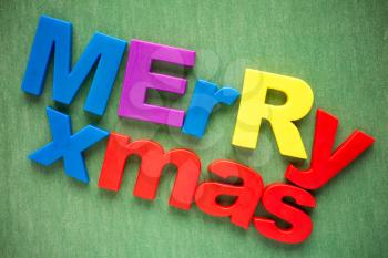 Merry xmas written in a colorful plastic letters