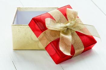 Open gift box on the white wooden background
