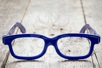 Blue plastic glasses on old wooden floor