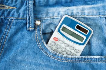 Digital electronic calculator in blue jeans pocket
