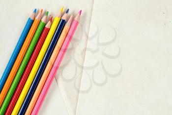 Colorful crayons with copy-space on paper background,education frame concept.