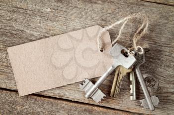  Bunch of  keys with blank tag on the wooden background