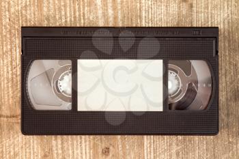 VHS video tape cassette on wooden background.Copy-space.
