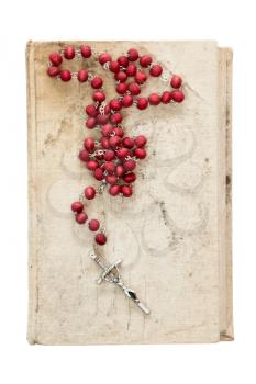 Catholic rosary on old book,isolated on white background